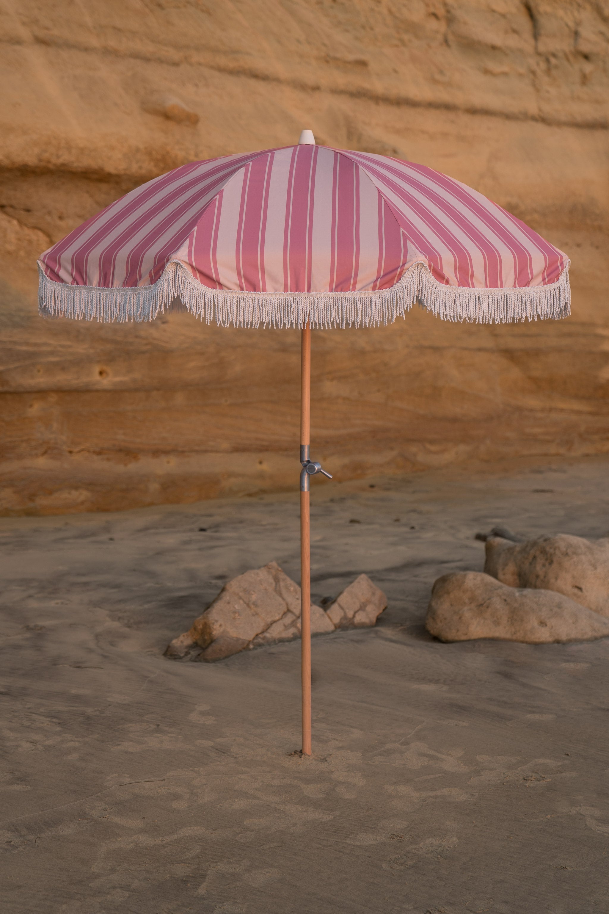 finkle fringed patio umbrella from 1950s Wind & Sea Classic Pink Stripe Fringe Tassel Patio & Beach Umbrella